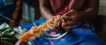 Woman weaving Fijian garland Adobe Stock 286461273