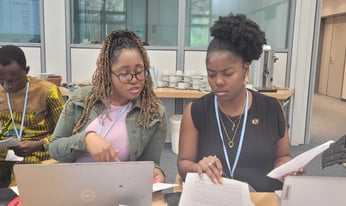 Bridet Burns sits at a microphone