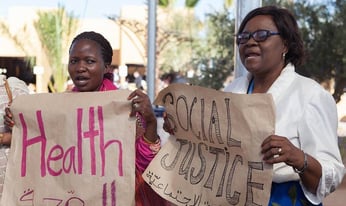 a group of people looking towards crowd at a panel