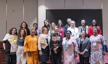 a team of women stand for a group photo