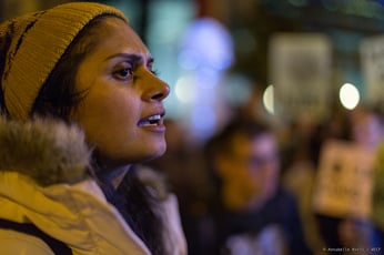 a woman speaks with a crowd at COP25
