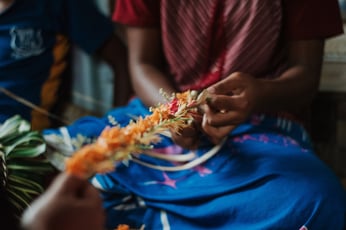 Woman weaving Fijian garland Adobe Stock 286461273