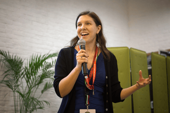 a person speaking enthusiastically into a microphone