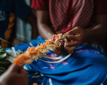 Woman weaving Fijian garland Adobe Stock 286461273